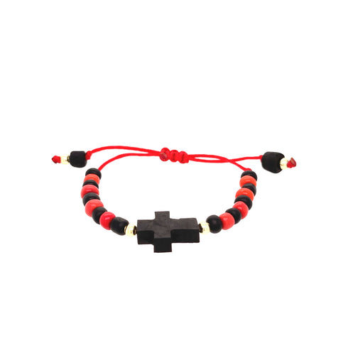 This genuine Azabache bracelet for baby combines spiritual protection with style, showcasing a central black cross design. It is crafted with an adjustable red rope featuring black bead ends and alternating red and black beads that create an eye-catching pattern.